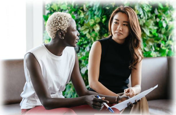 Two women sitting next to each other having a conversation