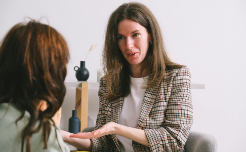 Lady talking to her patient explaining our therapist program.