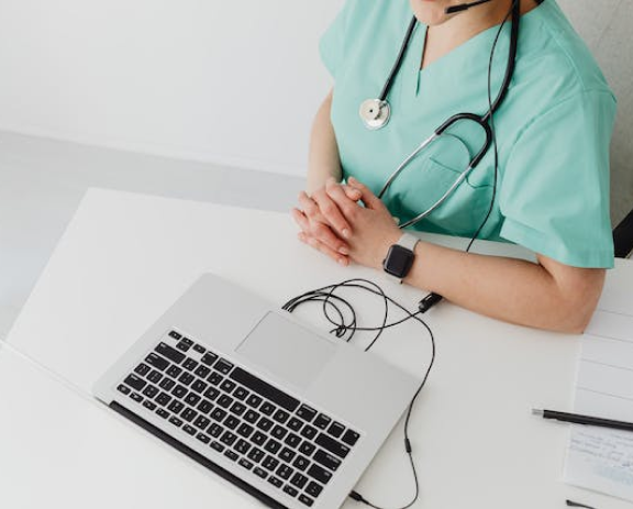 Medical professional meeting with a patient over a virtual call.