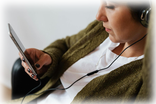 Person on there mobile device listening and setting up there music playlist before a ketamine session.